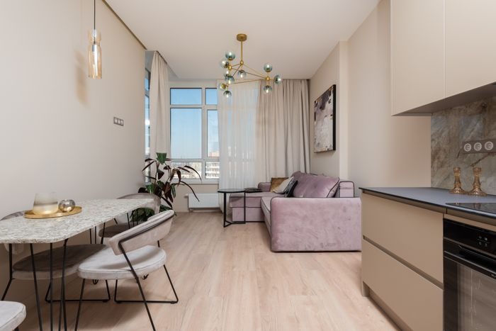 Foldable dining table and modular sofa in a compact Ajman apartment